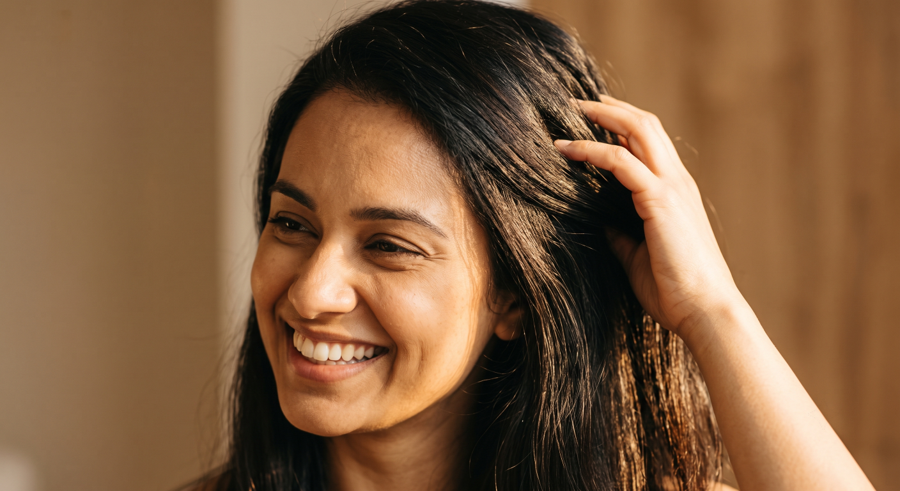 Person with healthy, flake-free hair after dandruff scalp treatment